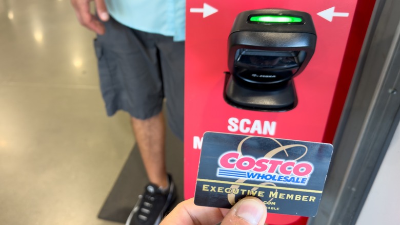 hand scanning Costco Executive Membership card