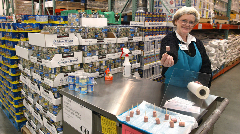 Woman handing out hot dog pieces at Costco sample station
