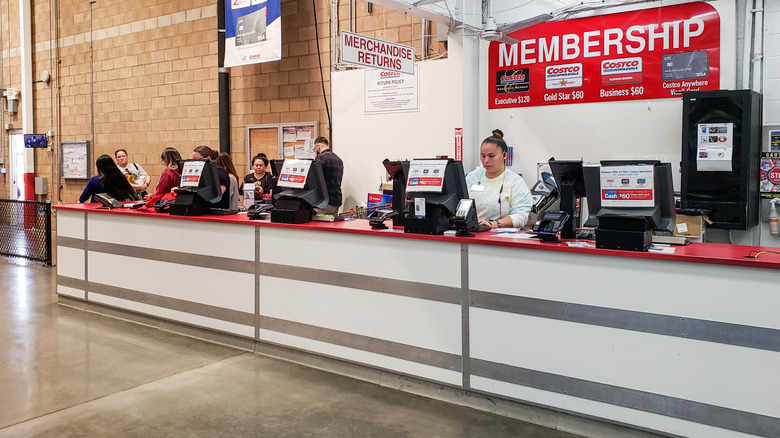 employees at membership counter of Costco
