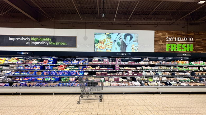 Shopping cart in cheese aisle of Aldi store
