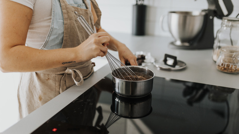 A person cooking on induction stove