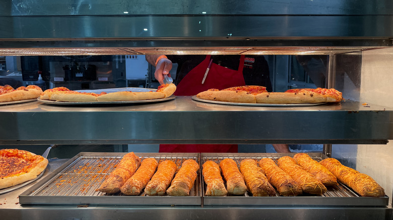 Chicken bakes and pizzas on the warmer at Costco's food court