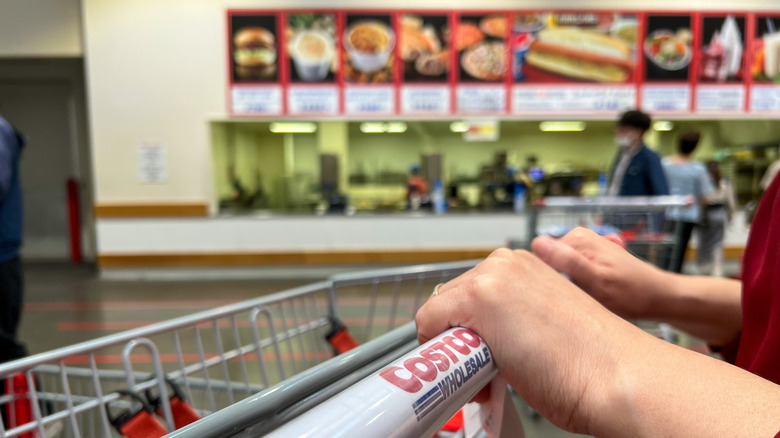 a costco shopping cart with the food court in the background