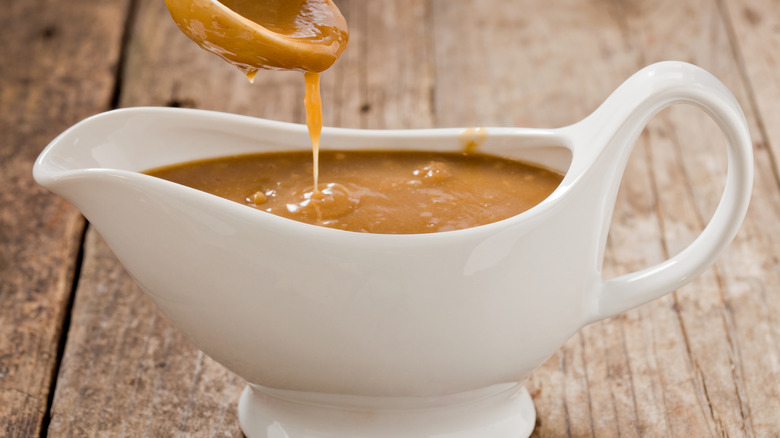 Gravy getting poured into a gravy boat