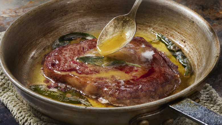 basting steak with spoon