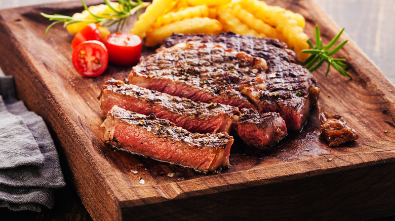 ribeye with fries in background
