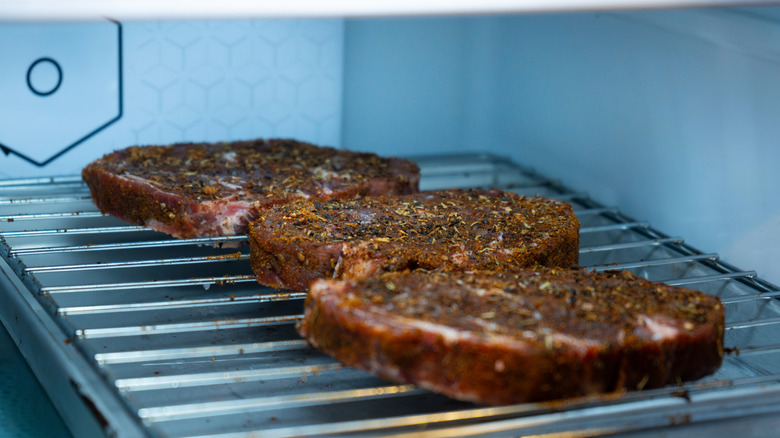 dry brined steak on grate