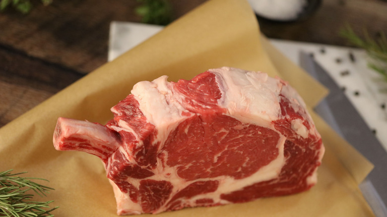 raw ribeye in brown paper