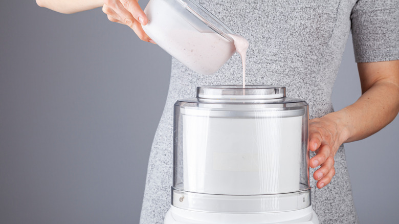 Person pouring mixture into ice cream maker