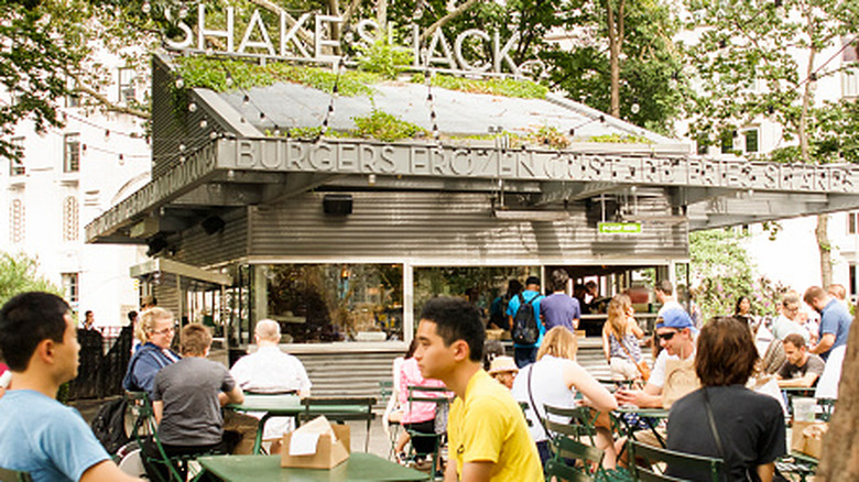 Customers dine outside Shake Shack.