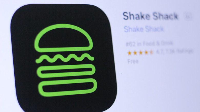 The Shake Shack app icon glows on a digital screen.
