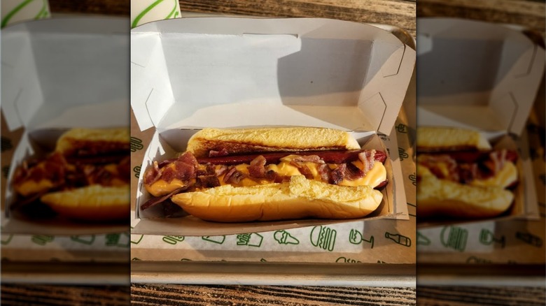 Shake Shack hot dog topped with cheese and bacon