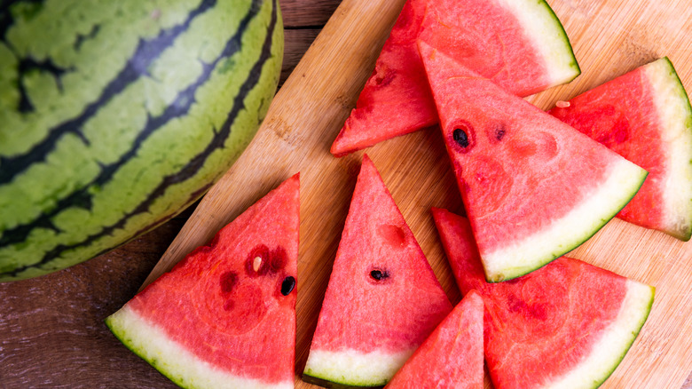 slices of watermelon next to whole watermelon