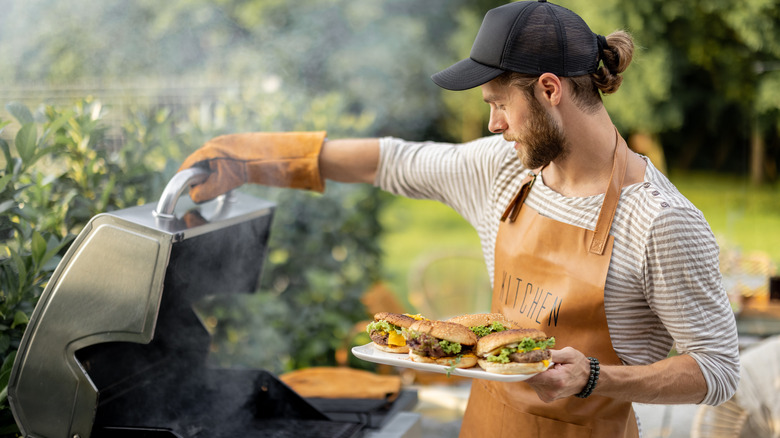 Man grilling burgers outside