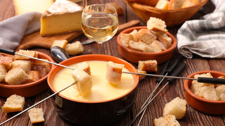 Dipping bread into fondue
