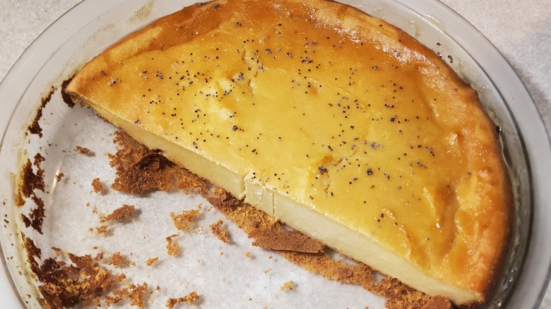 Half of a baked cheesecake with poppy seeds