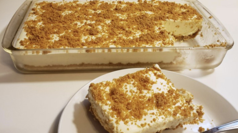 Glass pan of Woolworth's cheesecake with slice