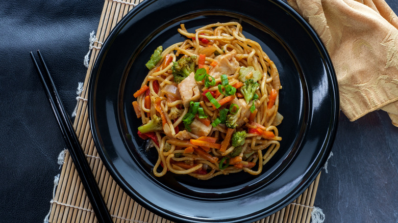Bowl of lo mein with chopsticks
