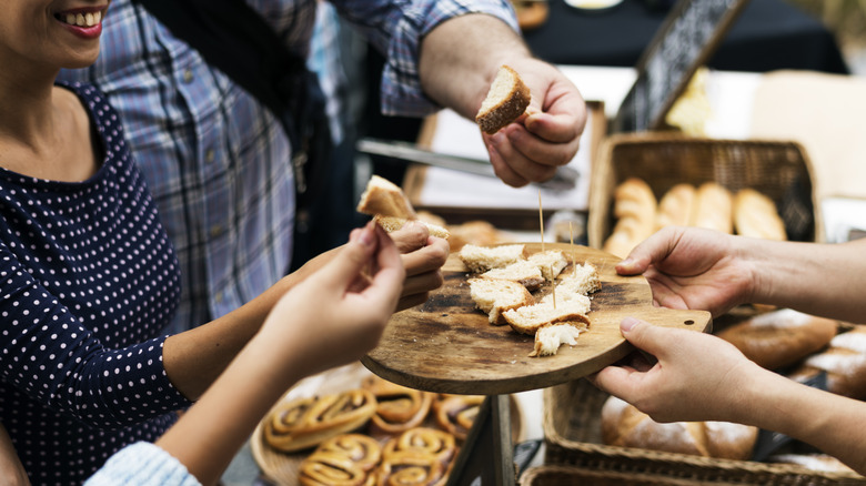 customers trying samples of breads