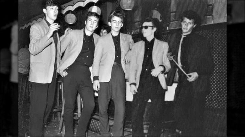 An old black-and-white photo of the early Beatles lineup at the Indra Club in Hamburg.