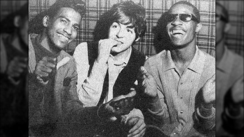 Grainy black-and-white photo of Charlie Foxx, Paul McCartney, and Stevie Wonder sitting together at the The Scotch of Saint James club.
