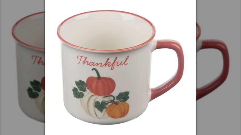 Camper mug decorated with pumpkins that reads "thankful"