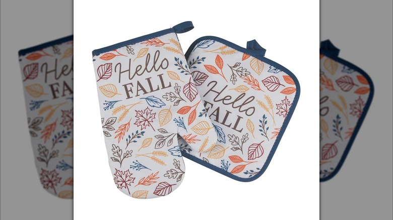 Autumnal oven mitt and hot pad set that read "hello fall"