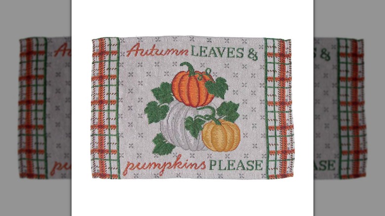 Tapestry placemat that reads "autumn leaves and pumpkins please"