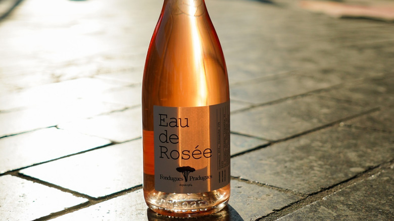 Close up of Eau de Rosee set on tiels of a patio