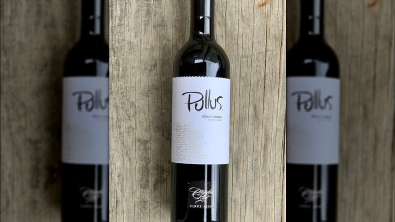 bottle of pullus wine on a wooden table