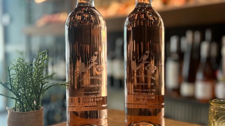 Two bottles of Rosé of Mourvedre on a table with greenery