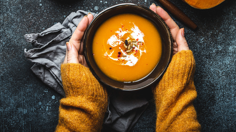 Hands on a bowl of soup