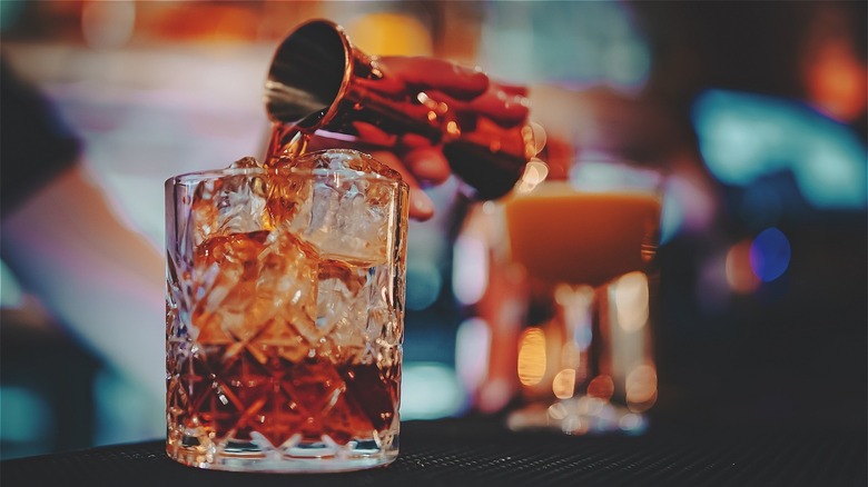  Sweet vermouth being poured into glass 