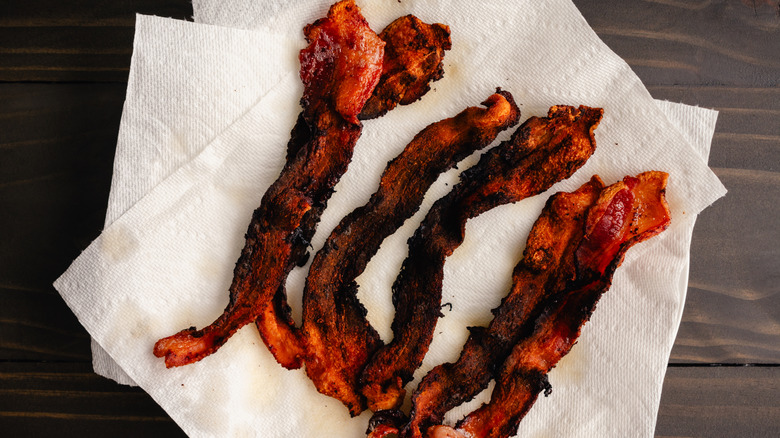 overcooked bacon on a paper towel