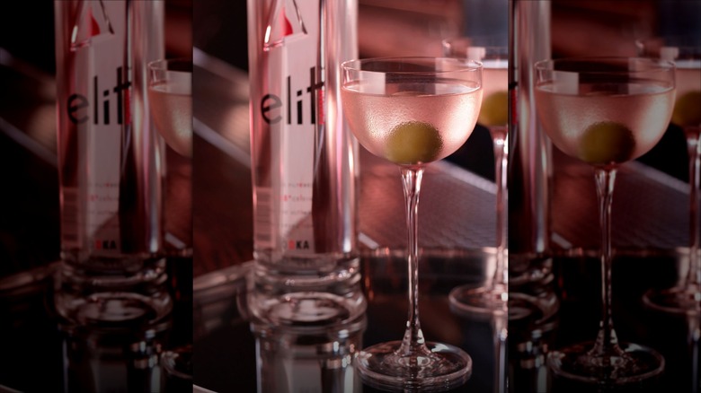 dirty vodka martini with a bottle of Stoli Elit vodka in the background