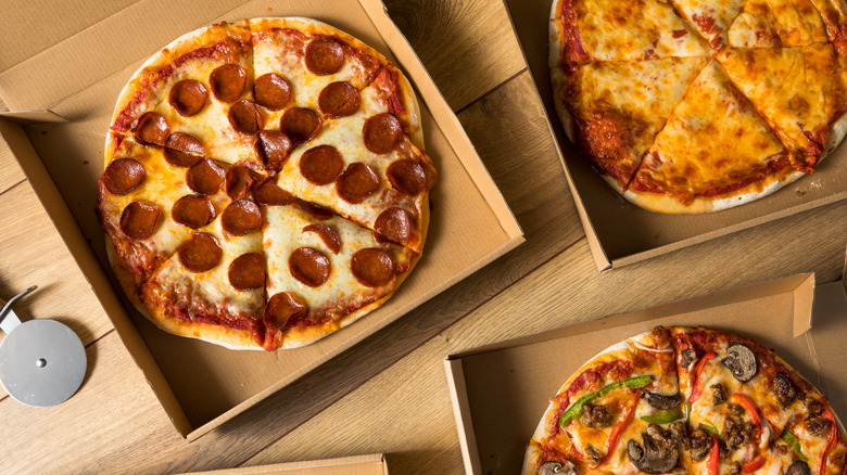 Pizza pies in boxes