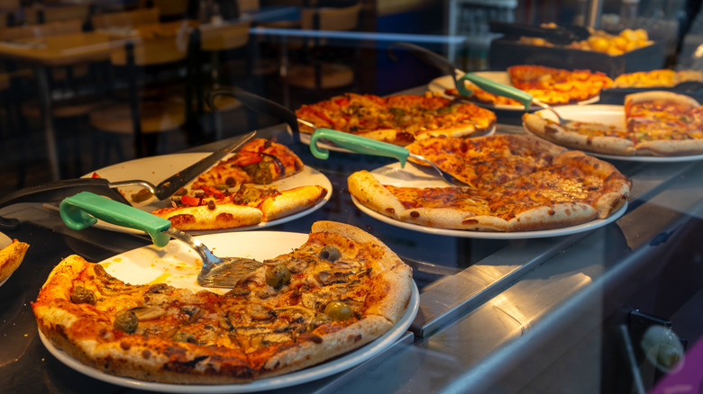 Array of pizzas at buffet