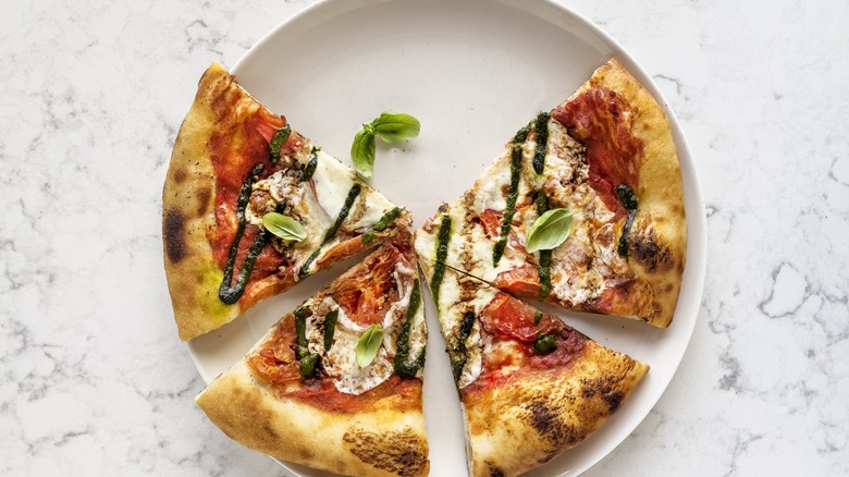 Plate with four pizza slices