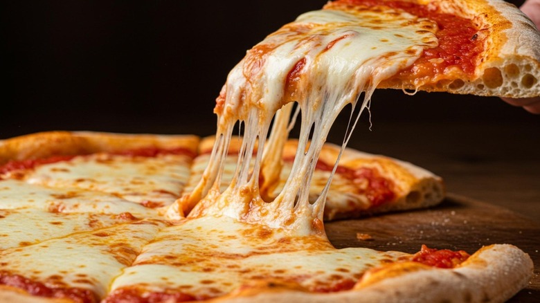 Stringy cheese on a pizza slice