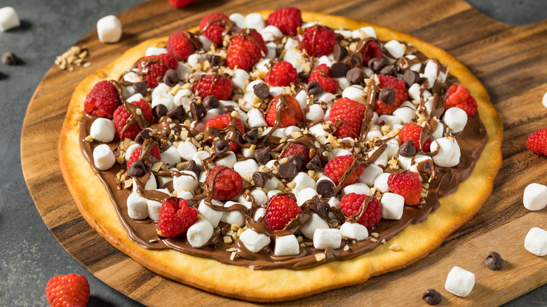 Dessert pizza with marshmallows and raspberries