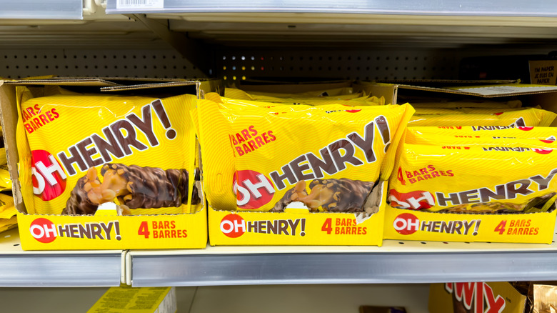 Packs of Oh Henry! candy bars sit on a store shelf.