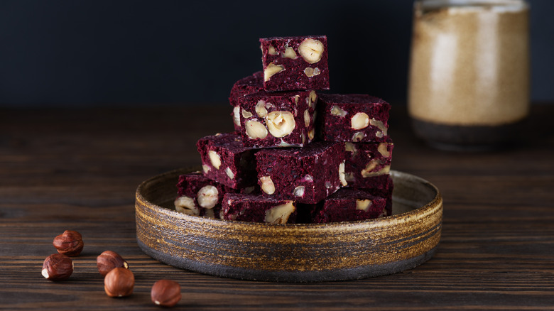 plate of beet brownies with hazelnuts