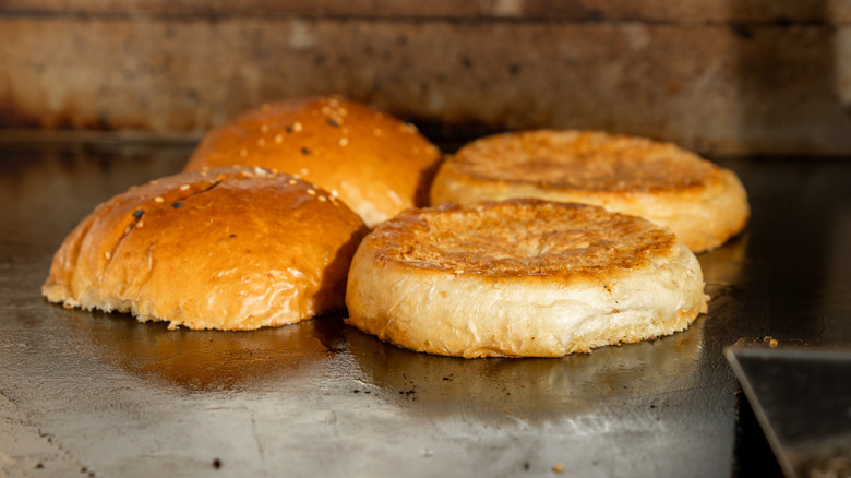 Burger boans toasting on a griddle
