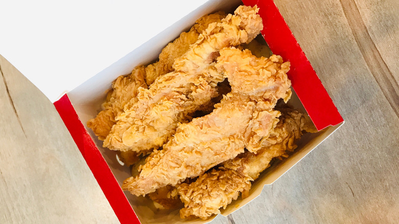 Top view of an open box of KFC chicken tenders