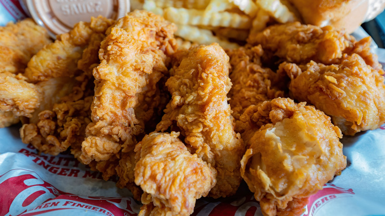 Closeup of Raising Cane's chicken tenders with fries