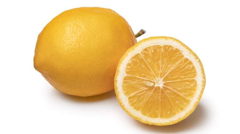 Whole and half Meyer lemon