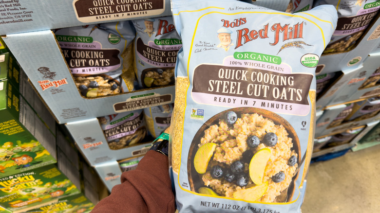 Customer holding a bag of Bob's Red Mill quick cooking steel cut oats