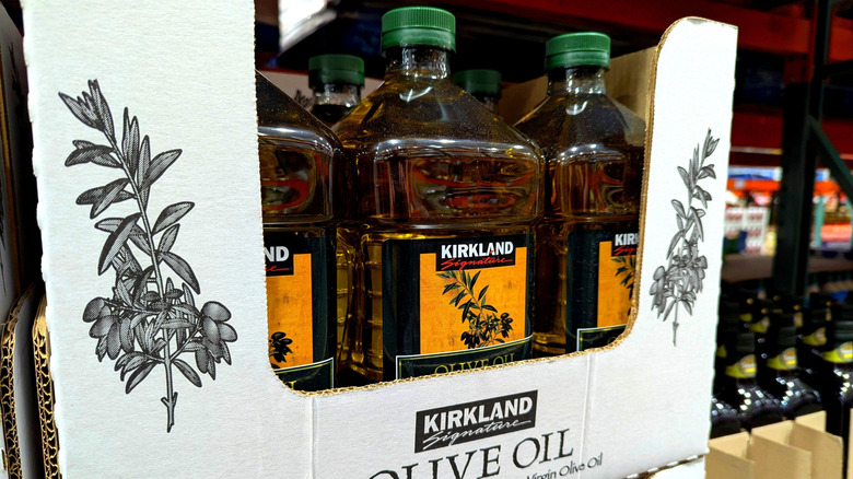 Bottles of Kirkland Signature olive oil on a shelf