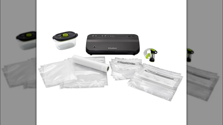 FoodSaver Preserve vacuum sealer appliance with bags and marinade container on white background.
