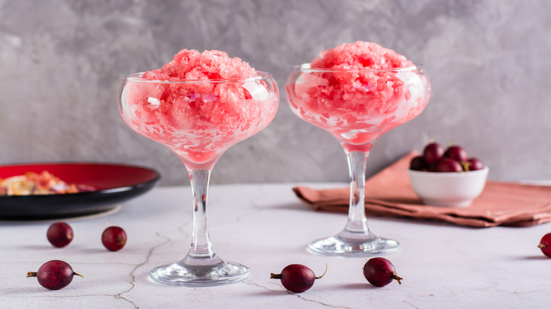 Glasses of frozen wine slushy and grapes